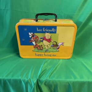 A yellow lunch box with winnie the pooh and friends on it.