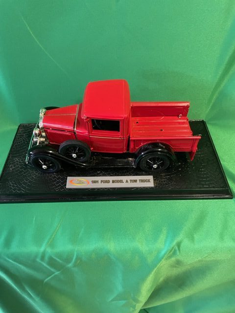 A model of an old red truck on display.